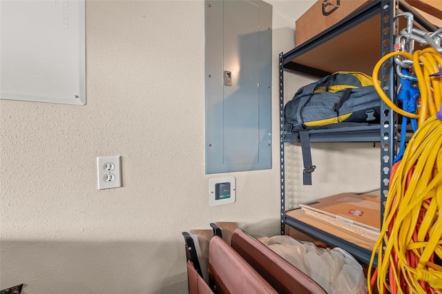 interior space featuring electric panel and a textured wall