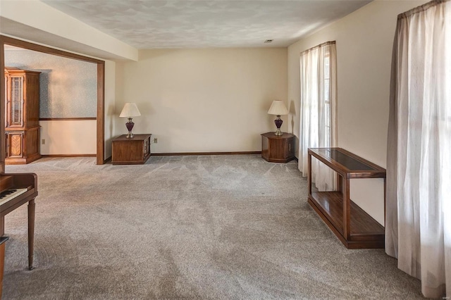 living area with carpet and baseboards