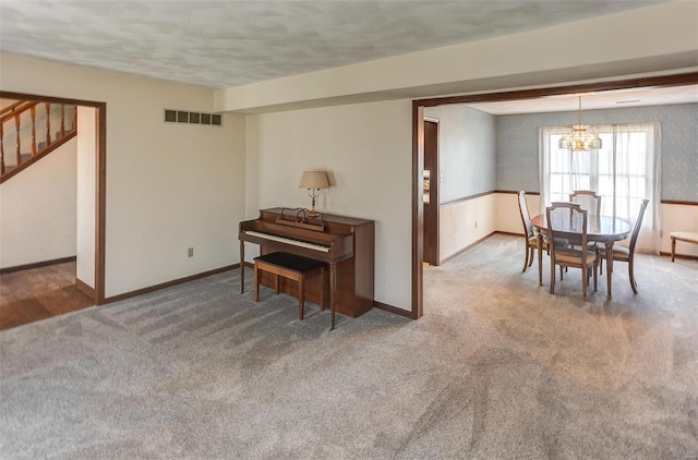 dining room with visible vents, baseboards, stairway, carpet, and a chandelier