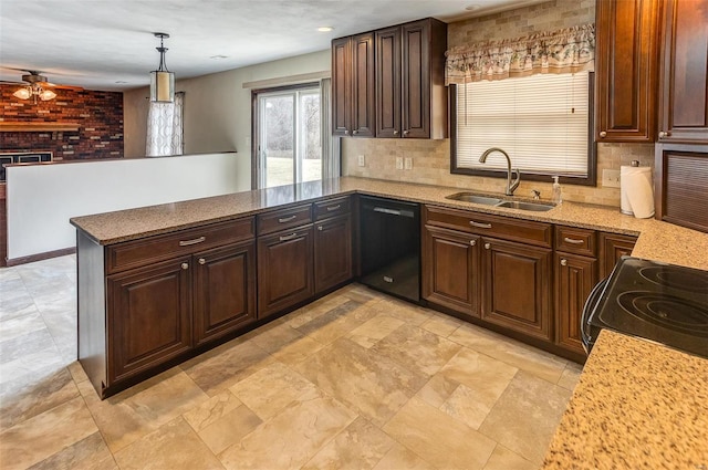 kitchen featuring decorative backsplash, a peninsula, black appliances, a fireplace, and a sink