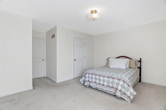 carpeted bedroom featuring visible vents and baseboards