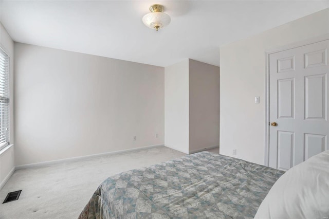 bedroom with visible vents, baseboards, and carpet