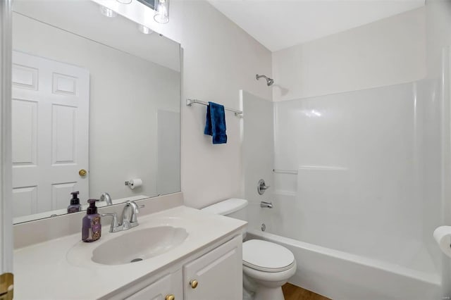 bathroom featuring vanity, toilet, and shower / bathing tub combination