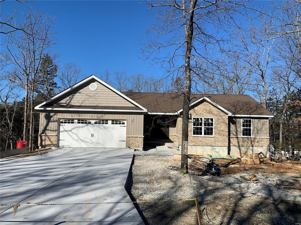 ranch-style house featuring driveway and an attached garage