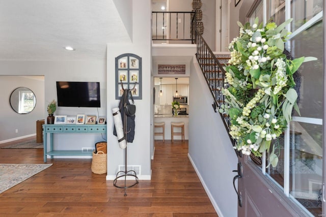 foyer featuring visible vents, wood finished floors, recessed lighting, stairway, and baseboards