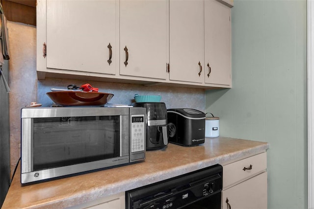 kitchen featuring white cabinetry, stainless steel microwave, light countertops, and dishwasher