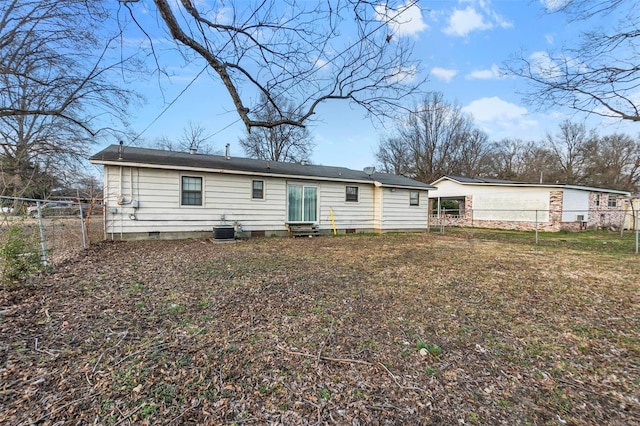 back of house featuring entry steps, crawl space, fence private yard, cooling unit, and a yard