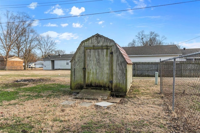 view of shed featuring fence