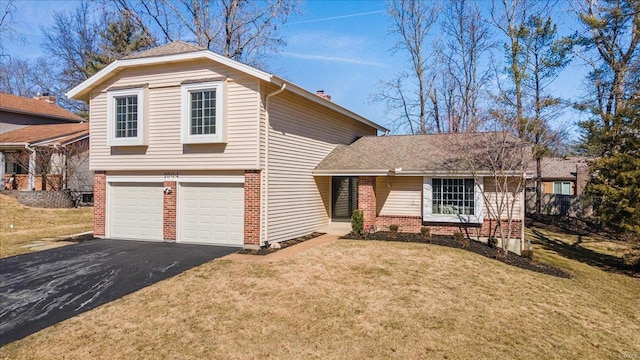 view of front of property with a garage, aphalt driveway, a front lawn, and brick siding