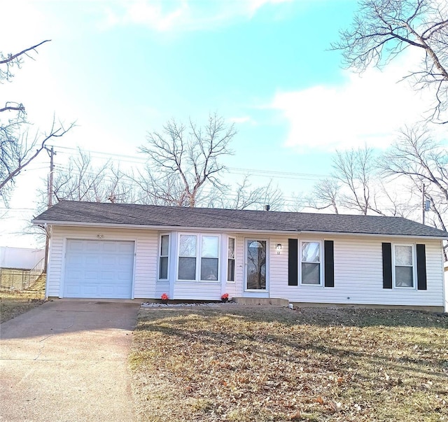 single story home with concrete driveway and an attached garage