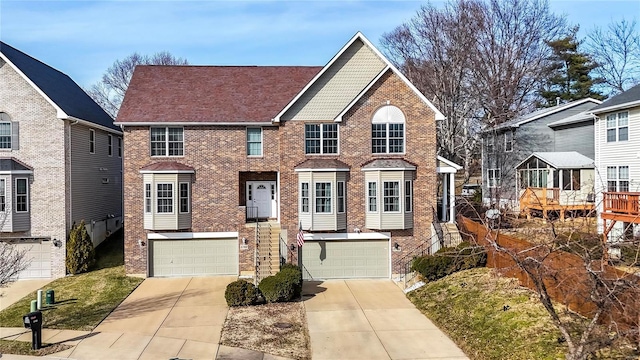 view of front of property featuring brick siding, driveway, and an attached garage