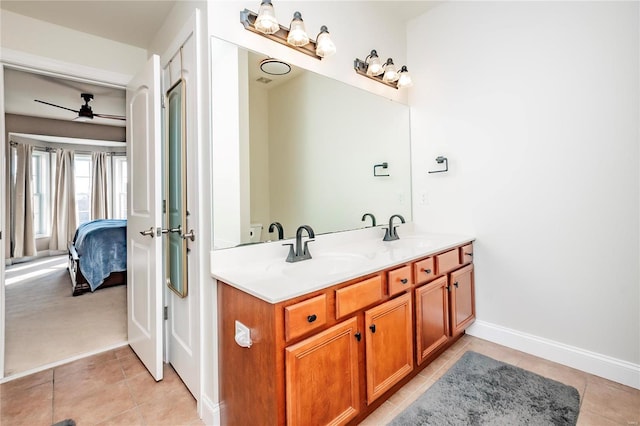 ensuite bathroom featuring double vanity, ensuite bath, a sink, and tile patterned floors