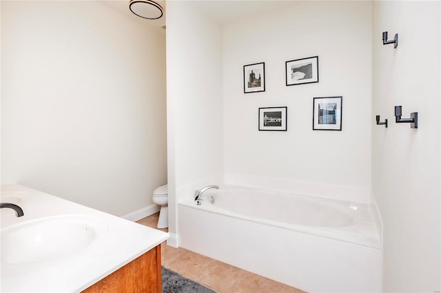 bathroom featuring toilet, vanity, a bath, and tile patterned floors