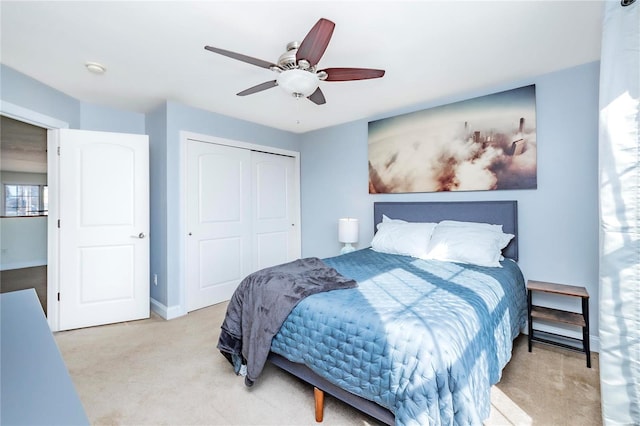 bedroom with carpet floors, a closet, baseboards, and a ceiling fan