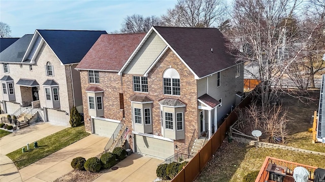 traditional-style home featuring driveway, brick siding, and an attached garage