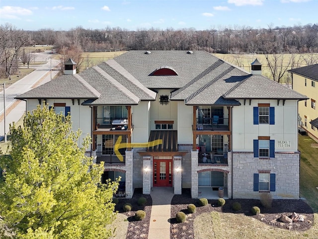 view of front of property featuring roof with shingles