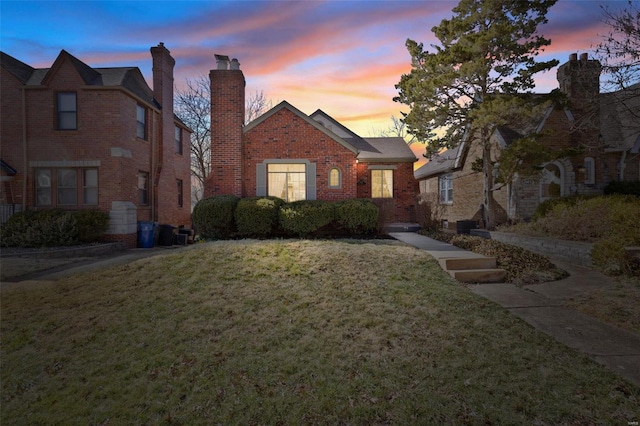 view of front of property with a front yard and brick siding