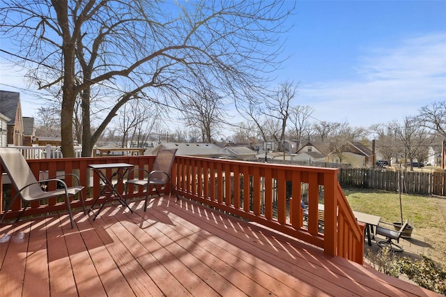 wooden terrace featuring a residential view and fence