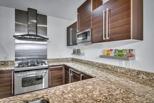 kitchen with wine cooler, stainless steel appliances, dark brown cabinets, wall chimney range hood, and light stone countertops