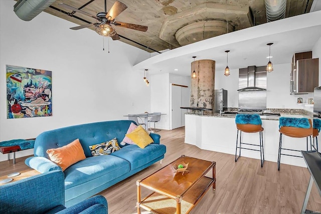 living room featuring light wood-style floors and ceiling fan