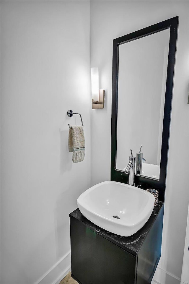 bathroom with baseboards and vanity