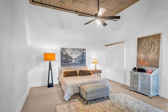 bedroom featuring a ceiling fan, carpet, and baseboards