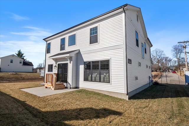 rear view of property with a yard