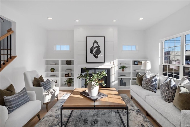 living room featuring recessed lighting, stairway, and wood finished floors