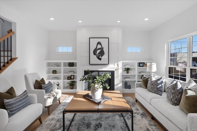 living room with stairway, wood finished floors, and recessed lighting