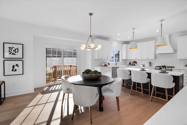 dining room featuring baseboards, recessed lighting, a chandelier, and light wood-style floors