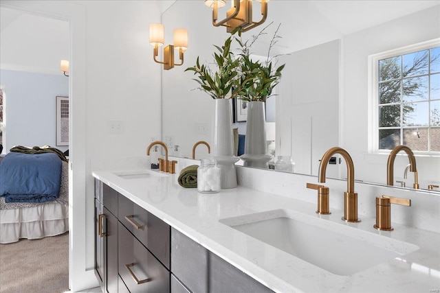 bathroom featuring double vanity, ensuite bath, and a sink