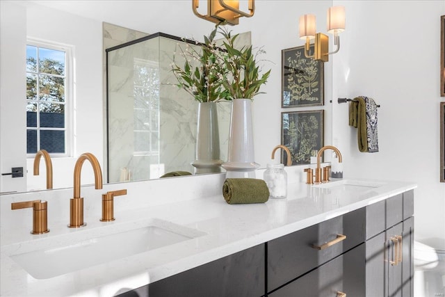 bathroom with double vanity, a shower stall, and a sink