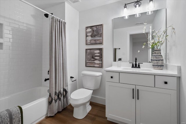 bathroom with toilet, shower / tub combo, wood finished floors, vanity, and baseboards