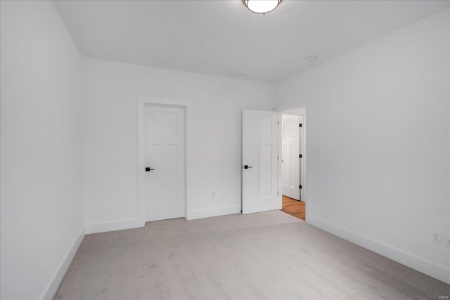 unfurnished bedroom with carpet flooring and baseboards