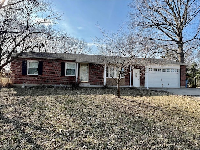 ranch-style home with concrete driveway, brick siding, and an attached garage