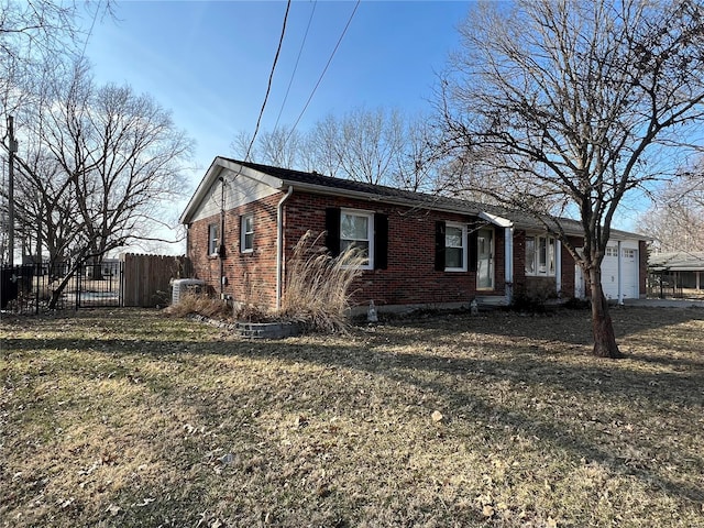 ranch-style home with an attached garage, a front yard, fence, and brick siding