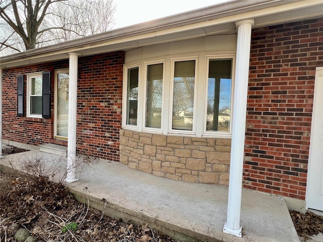 view of property exterior with stone siding and brick siding