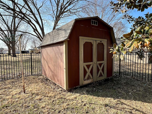 view of shed featuring fence