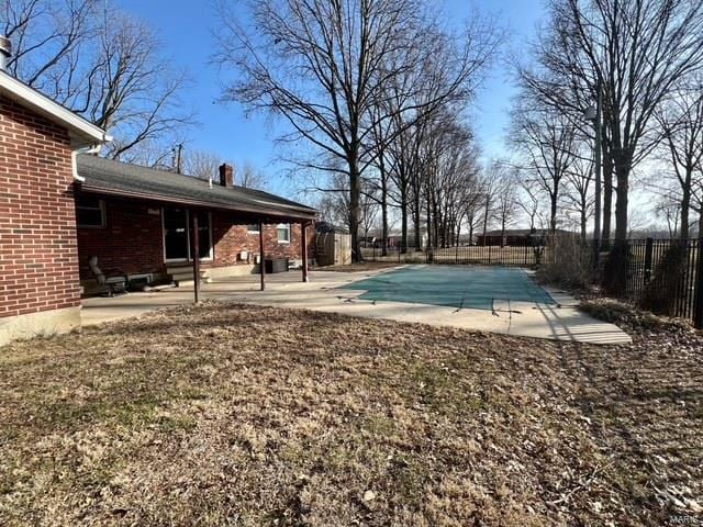 view of swimming pool featuring a fenced in pool, a fenced backyard, and a patio