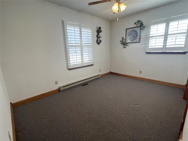 empty room with a baseboard heating unit, carpet flooring, plenty of natural light, and baseboards