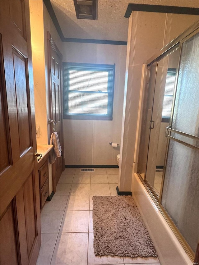 bathroom featuring visible vents, toilet, tile patterned floors, a textured ceiling, and vanity