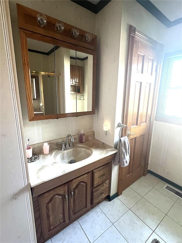 bathroom featuring visible vents, a shower with door, vanity, and tile patterned floors