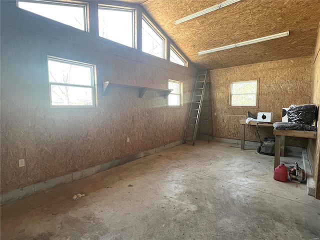 interior space with concrete flooring and vaulted ceiling