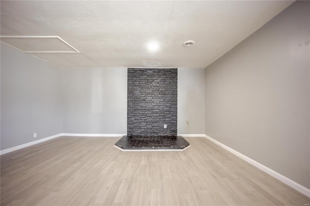 empty room with visible vents, baseboards, and wood finished floors