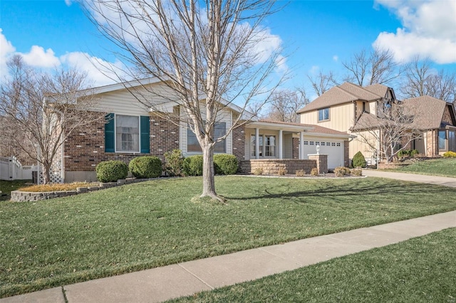 view of front of home featuring a garage, a front lawn, brick siding, and driveway