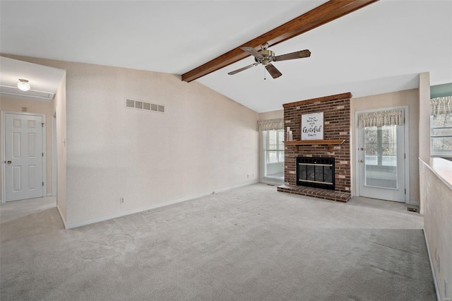 unfurnished living room featuring visible vents, a healthy amount of sunlight, and carpet floors