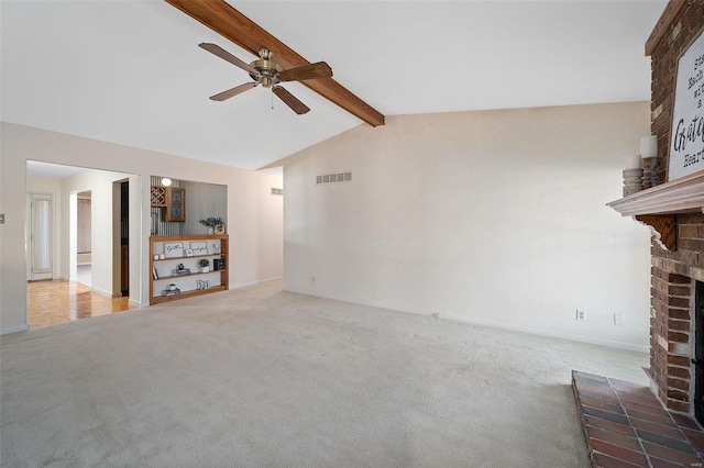 unfurnished living room featuring carpet, vaulted ceiling with beams, a fireplace, and visible vents