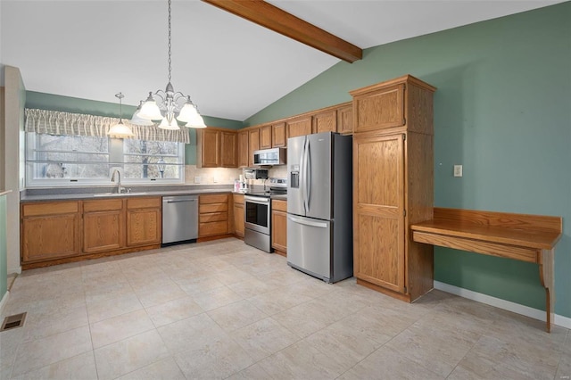 kitchen with baseboards, lofted ceiling with beams, a sink, appliances with stainless steel finishes, and brown cabinets