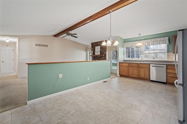 kitchen featuring visible vents, lofted ceiling with beams, stainless steel appliances, brown cabinetry, and baseboards