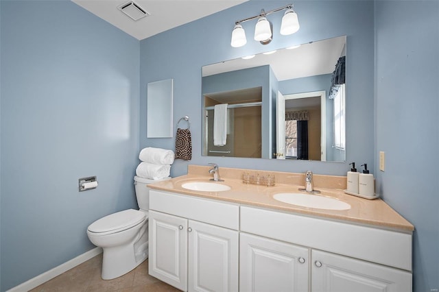 bathroom featuring tile patterned floors, toilet, visible vents, and a sink